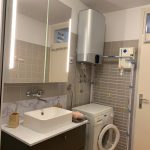 Moderno opremljena kopalnica s paralnim strojem